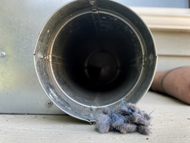 Boynton Beach Dryer Vent Cleaning technician using specialized equipment to clear severe dryer vent blockage in Boynton Beach